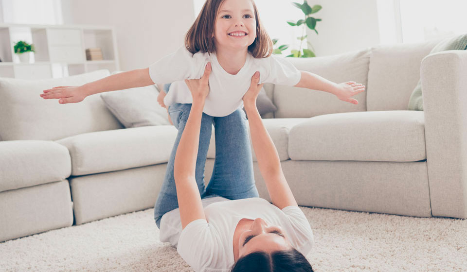 Mum and daughter playing on a carpet