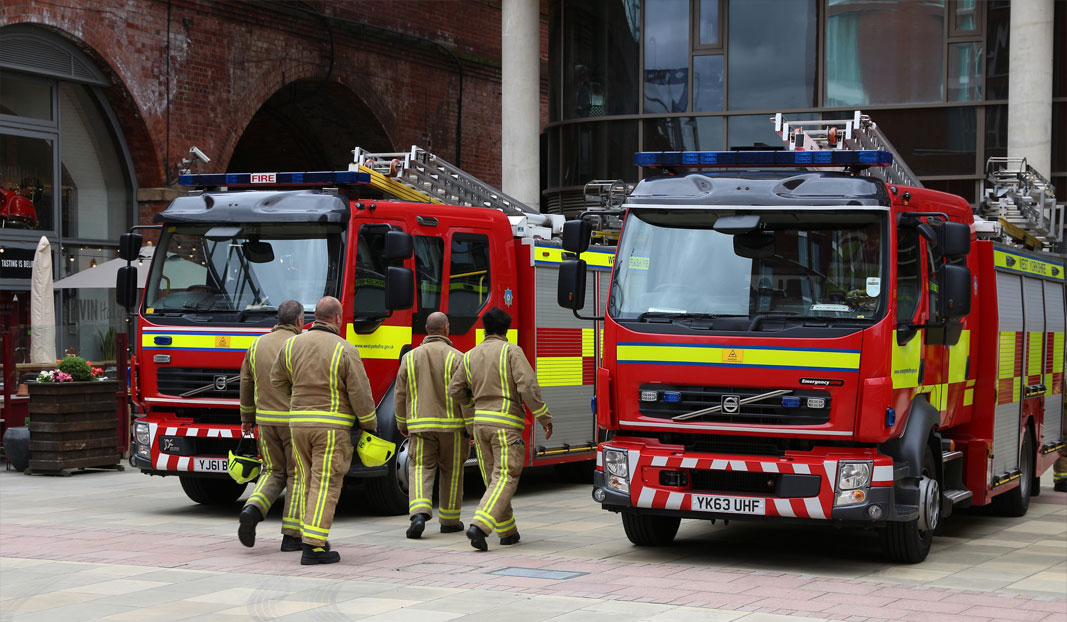 Firemen casually walking up to fire truck