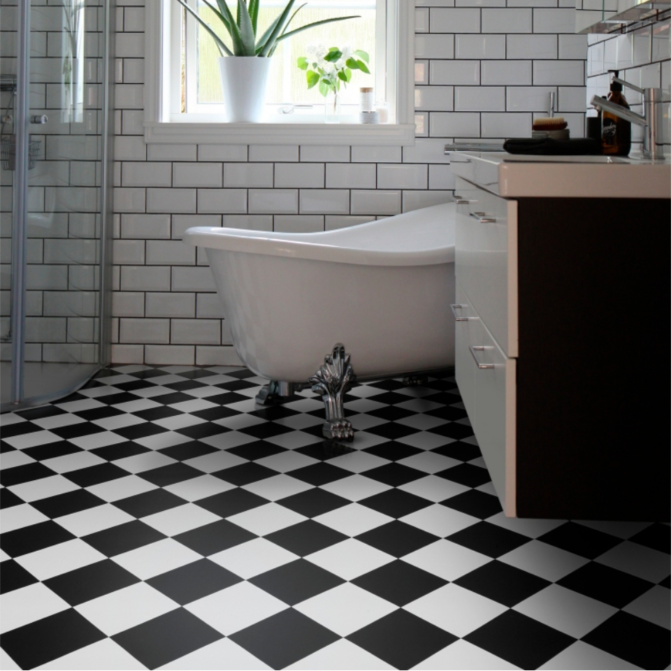 Black and white tile ffect vinyl in bathroom with rolltop bath