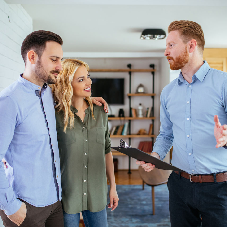 Man and woman having a home consultation with a professional.