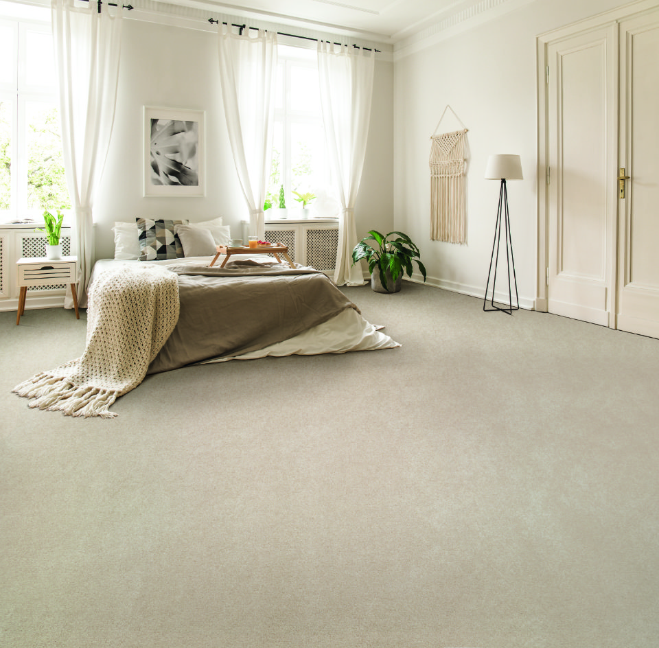 Magical feeling saxony carpet in a bedroom with a bed on it