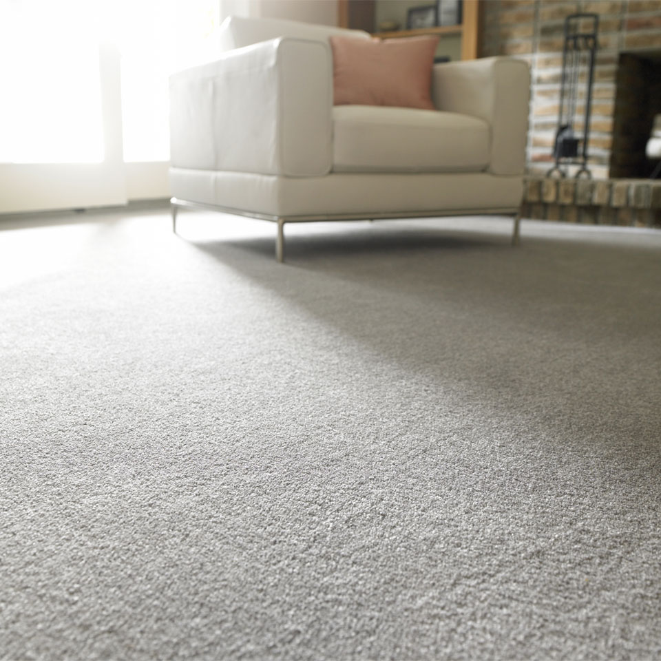 White armchair on grey carpet