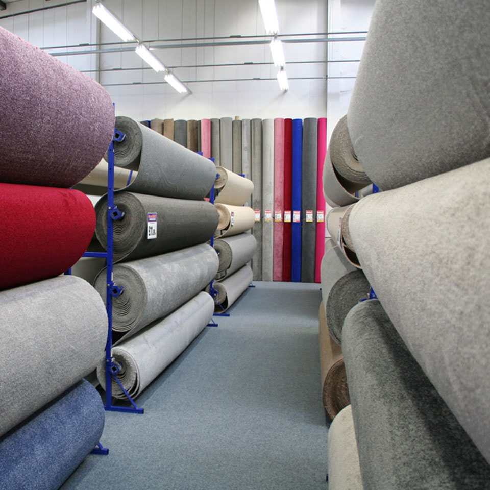 Cabin style lounge with fur blankets and sofa and beanbag on a rug with wooden floor