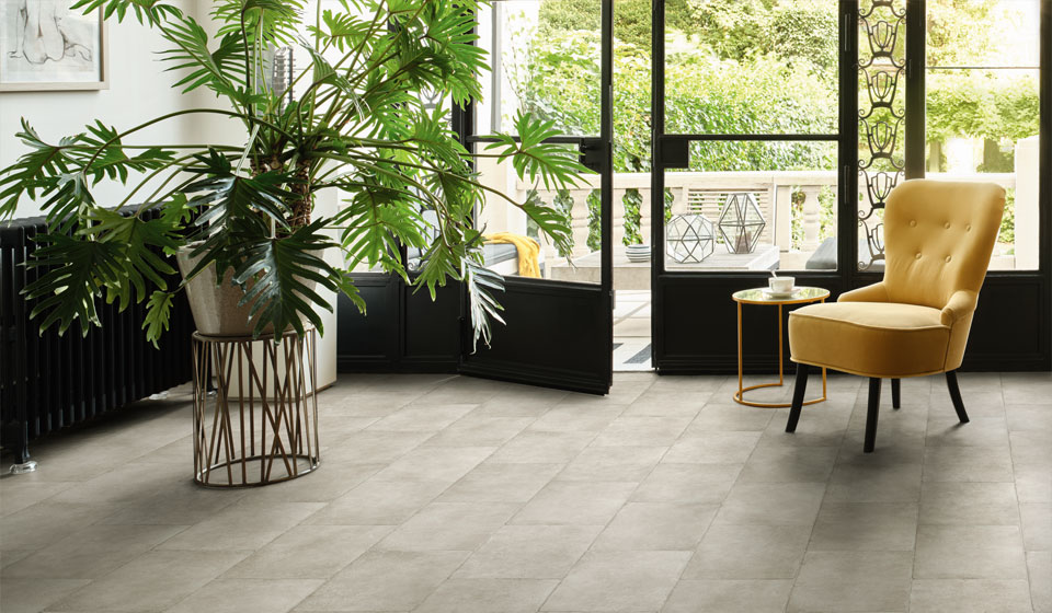 Vinyl floor in an entrance way with large plant and comfy yellow armchair